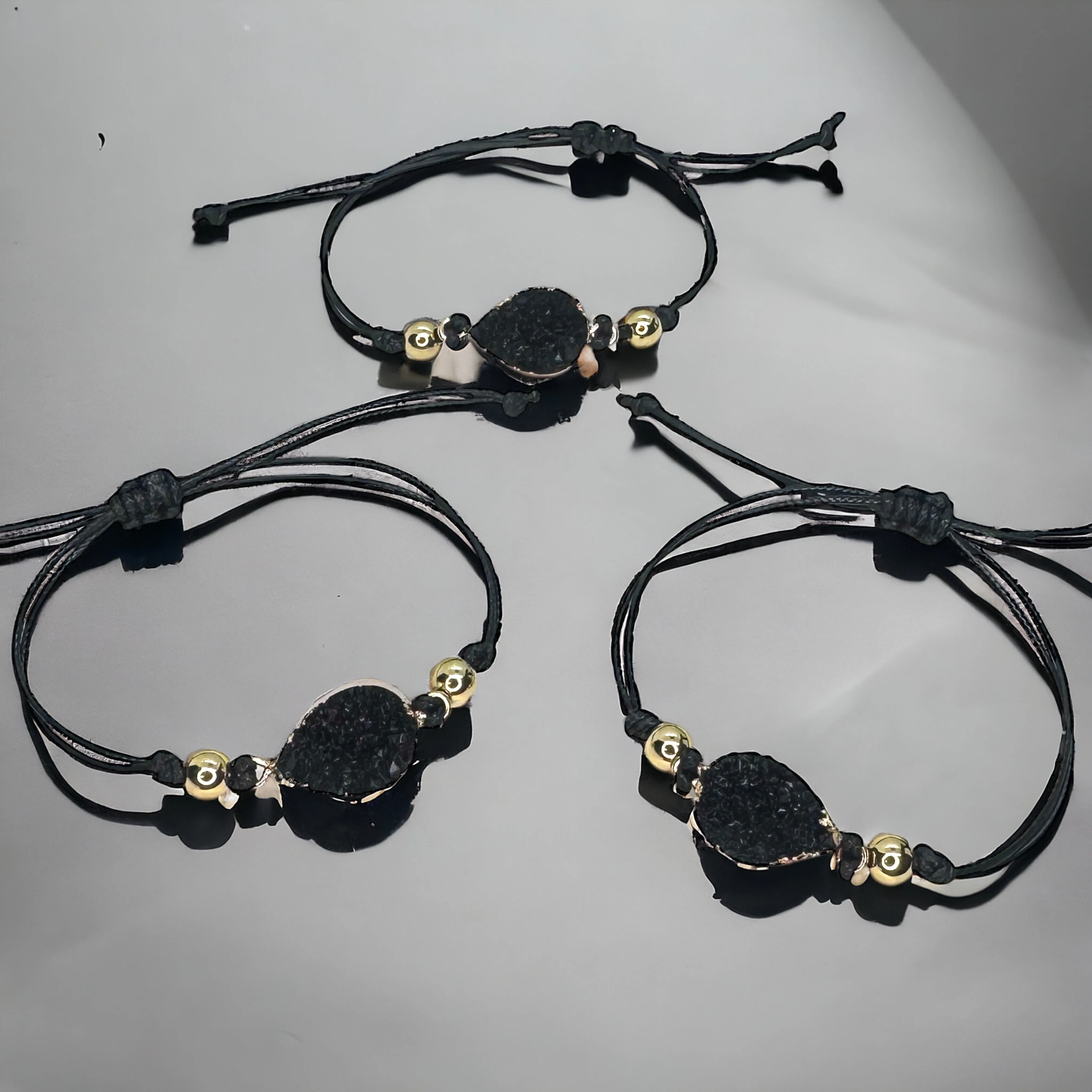 Black Leather Bracelet with Gold and Black Charm